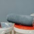 buckets of bluish-gray exterior paint with a paint roller